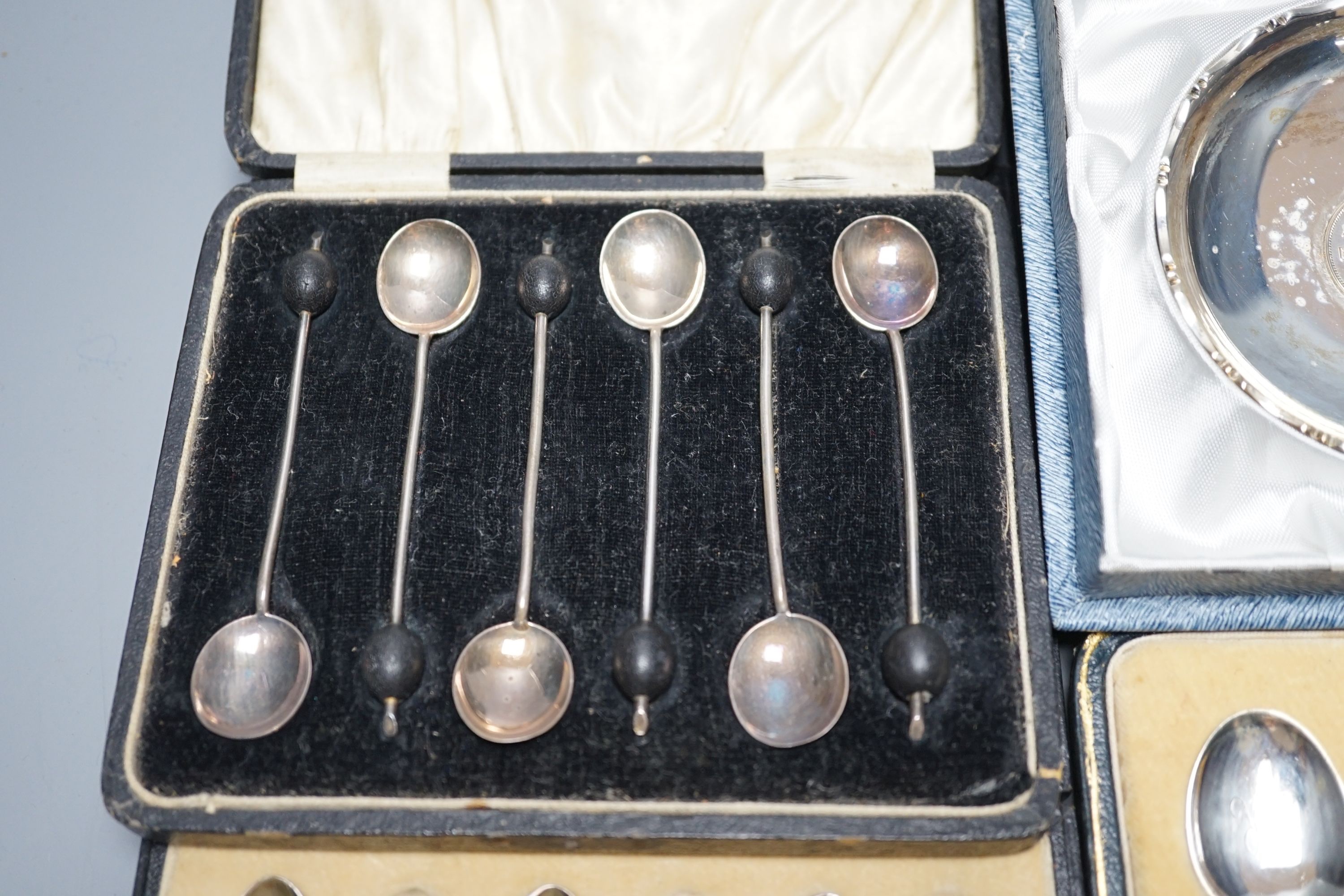 Two cased sets of six silver coffee spoons including enamel(a.f.) and bean end and three other cased sets including teaspoons with tongs, pepperettes and dish.